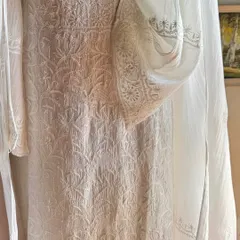 A detail shot focusing on the sleeve and side panel, highlighting the fine 'jaali' work and delicate floral patterns.