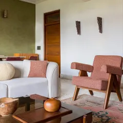 For Apartment 5026, we revived a family home by honoring its Art Deco roots. The living room features reclaimed terrazzo floors and furniture with vintage silhouettes, blending global influences with a character that is unmistakably Mumbai.