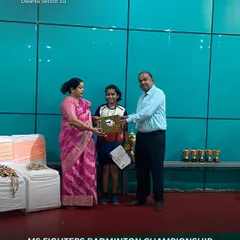 The joy of victory is unmatched. A participant proudly accepts her award at the MS Fighters Badminton Championship, a successful event that brought together talented players from across the region.
