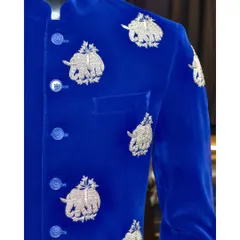 A close-up of our royal blue velvet bandhgala. The silver threadwork of the elephant motifs is incredibly detailed, showcasing the fine craftsmanship that goes into each garment.