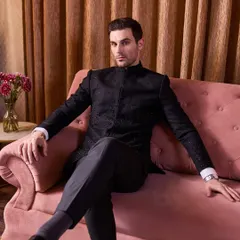 For a classic cocktail event, nothing beats a black bandhgala. This one is elevated with restrained black-on-black bead and thread embroidery for a touch of sparkle.