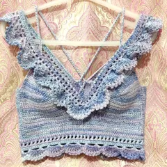 A custom-made 'Masakali' bralette top in a beautiful blue-purple variegated yarn. It features delicate lace details, off-the-shoulder ruffles, and adjustable straps for a perfect, comfortable fit.