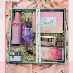 Pamper her with a premium cosmetics collection to make her feel special. This gift box includes a Jimmy's Cocktails mixer, bath and body products, and makeup essentials.