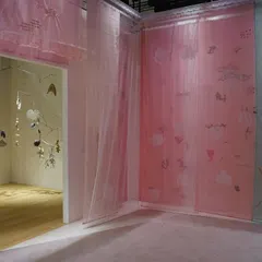 A wider view of the 'Feel More' installation, showing the interplay of pink and green translucent panels. The soft gradients of color conjure a hazy, abstract landscape where tranquility meets intrigue.