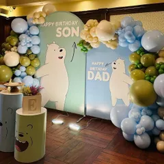 A cool and unique "We Bare Bears" theme for a joint father-son birthday celebration. The decor features two backdrops, one for "Dad" and one for "Son," with the characters and a beautiful balloon arch in shades of blue, green, and cream.