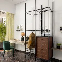 This open-frame wardrobe and study unit in a 6BHK Mumbai residence is a perfect example of multi-functional design. It provides storage, a workspace, and a strong graphic element to the room, all while feeling light and airy.