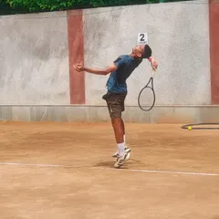 The serve is a weapon, and we forge it through thousands of repetitions. This is one of our U-16 players perfecting his service motion during a practice session for an AITA tournament on our clay court.