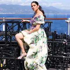 A powerful pose in the Yara Shoemaker gown, highlighting the high-low skirt and the intricate floral details on the bodice.