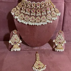 The complete modern ruby choker set, including the necklace, earrings, and maang tikka. This is a popular rental for receptions.