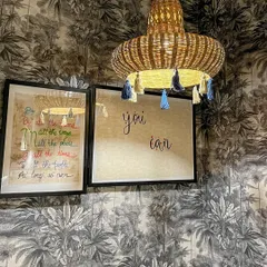 Here are two of my favorite upcycled creations side by side. The hanging lamp is made from a cane basket I found at a local Bangalore market, decorated with tassels. Next to it is a custom artwork I made using leftover wallpaper and IKEA frames to cleverly hide my home's MCB board.