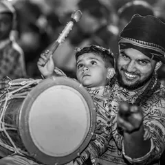 The same heartwarming father-son moment in timeless black and white, focusing on their shared expression of joy and concentration.