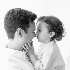A tender black and white version of a father and son nose-to-nose portrait. The lack of color draws all the attention to their intimate connection.