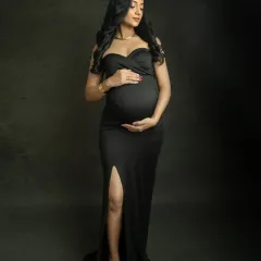 A solo portrait that is both strong and graceful. The simple black gown highlights your beautiful silhouette, creating a timeless and elegant image of the mother-to-be.