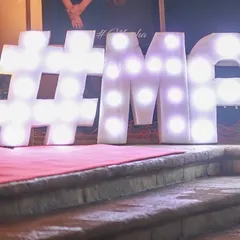 Large, illuminated marquee letters are a great way to personalize your event space. Here, we created the couple's custom hashtag in bold letters at the entrance of their reception.