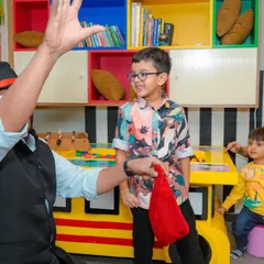 A young boy watches with a smile as the magician performs a trick just for him.