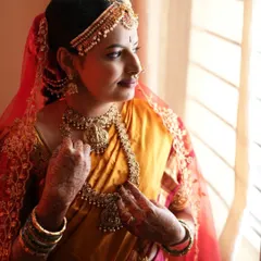 This side profile showcases the complete Muhurtham look, including the traditional hairstyle and headpiece. The makeup is designed to be flawless from every angle, with a focus on a smooth, long-lasting base.