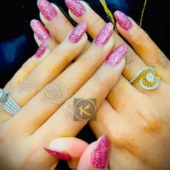 You can never go wrong with a bit of sparkle. This is a full set of almond-shaped nail extensions with a vibrant pink glitter gel polish. It is a perfect look for parties, weddings, or any time you want to feel extra glamorous.