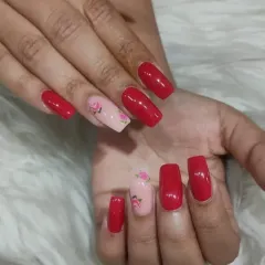 Another angle of the popular rose and red manicure. The contrast between the bright red and the soft floral design makes this a romantic and eye-catching choice.