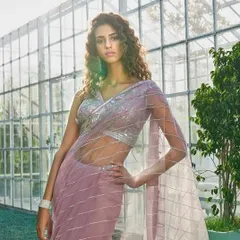 This was for a fashion shoot in a modern greenhouse setting. The makeup is fresh and contemporary, with an emphasis on glowing skin and natural-looking definition to suit the bright, sunlit environment. The curly hair adds to the relaxed yet chic vibe.