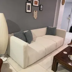 A modern, minimalist sofa I crafted for a client's apartment, showing how my designs can anchor a contemporary living space.