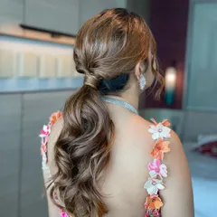 A chic and voluminous ponytail for a Haldi celebration. This style is practical yet stylish, keeping the hair off the face while still looking glamorous and fun.