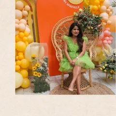 The beautiful mother-to-be at her 'Ray of Sunshine' themed baby shower. I used a peacock chair and a backdrop of warm orange and yellow balloons to create a radiant and joyful photo spot.