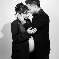An intimate embrace captured in a classic black and white style. This pose emphasizes the deep connection and shared excitement between the expecting parents during their maternity session.