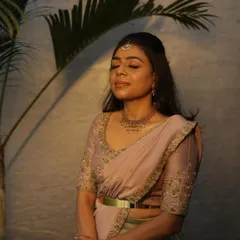A serene moment with Dr. Tushara in her custom pastel lehenga. The soft lighting highlights the delicate embroidery.