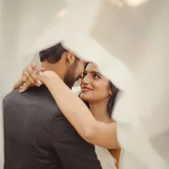 A soft and dreamy portrait of the couple seen through the bride's veil. This artistic shot creates a sense of intimacy and romance.