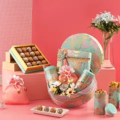 A full view of our luxurious Rakhi hamper collection. The combination of a round floral box, a matching basket, and a box of premium laddus creates a truly grand and memorable gift.