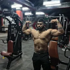 A powerful front double biceps pose. This is a staple in bodybuilding for showcasing arm size and peak.