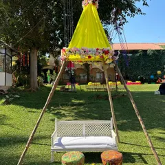 We created this charming teepee tent seating for the bride during her Mehandi. The yellow drapes and floral accents make it a unique and fun focal point for the celebration.