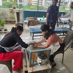 A glimpse of a daytime session on the terrace. You can see the open-air setup, with participants working on the wheel against the backdrop of the city.