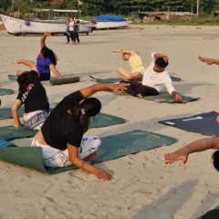 Flowing together with the rhythm of the waves. This side-body stretch feels incredible when you're grounded in the soft sand, connecting your movement to the natural world around you.