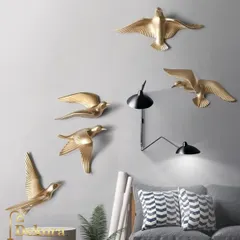A set of five metal birds, shown here in a living room, adding a simple yet elegant natural touch.