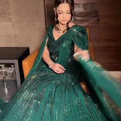 Capturing the movement and shimmer of a Gaurav Gupta creation. The makeup was designed to match this energy, with a focus on glowing skin and dramatic eyes that complement the emerald green gown for a show-stopping cocktail look.