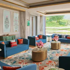 This lounge area at Taj Devi Ratn overlooks the Aravalli hills, and I designed it to feel like a royal court. Deep blue sofas, traditional Indian art panels, and custom carpets create a space that is both regal and inviting, perfect for conversation and relaxation.