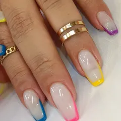 Why choose one color when you can have them all? This fun set features a classic French manicure base with a different vibrant neon color on each tip.