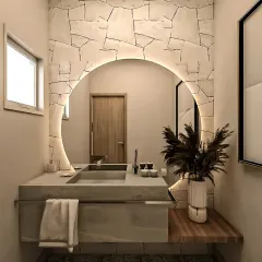 A statement powder room with a dramatic stone-patterned accent wall and a backlit circular mirror. The integrated concrete sink and vanity create a seamless and sculptural look.