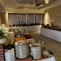 The calm before the storm: a wide shot of a large-scale buffet setup, with everything perfectly in place before the guests arrive.