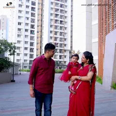 An urban setting can provide a modern backdrop for a family photoshoot. This candid walking shot captures a natural interaction between the family members.