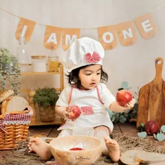 An apple a day. This curious moment of discovery adds another layer of charm to our popular baby chef milestone session.