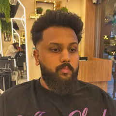 A frontal view of a men's haircut, showing the clean lines and expert styling that defines a fresh, sharp look.