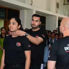 Here, one of my Kavach Warriors demonstrates a defense against a frontal chokehold during a university workshop. The focus is on creating space and disrupting the attacker's balance, techniques that are vital for personal safety and close-quarters combat.