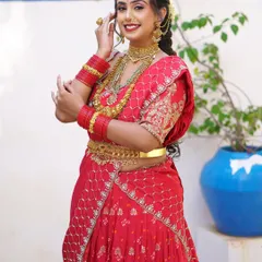 A full-length view of the red lehenga drape, showing how the pleats are arranged to create volume and a beautiful silhouette.