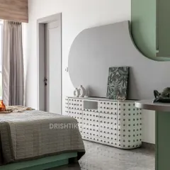 This nature-inspired bedroom features a unique cactus-themed credenza and soft green hues. The design uses curved shapes and gentle textures to create a calm and organic environment.