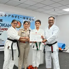 A student advances to the next level, receiving his green belt. Each belt promotion is a formal recognition of the student's improved technique, knowledge, and dedication.
