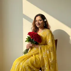 Another shot from my maternity series. A simple yellow saree, a flower in my hair, and a bouquet of red roses.