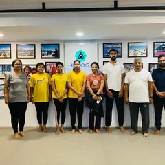 A group photo with participants after a special International Yoga Day session at the studio. These events are a great way to build community and introduce teams to the foundational practices of yoga.