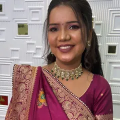 A close up of this engagement bride's beautiful smile. Her makeup features a bold mauve lip and shimmery pink eyeshadow, which looks stunning with her traditional saree.
